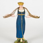 A Russian figurine of a dairy maid carrying a yoke, early 19th century