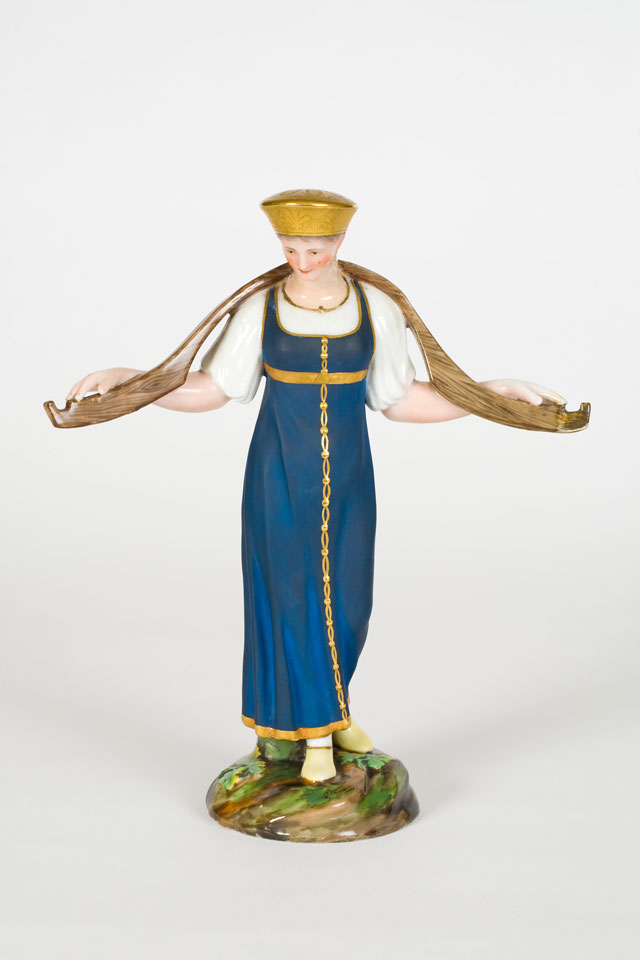 A Russian figurine of a dairy maid carrying a yoke, early 19th century