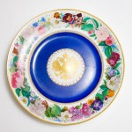 Large, circular Popov porcelain dish with gilt Russian eagle reserved on dark blue ground and rim decorated with brightly painted flowers
