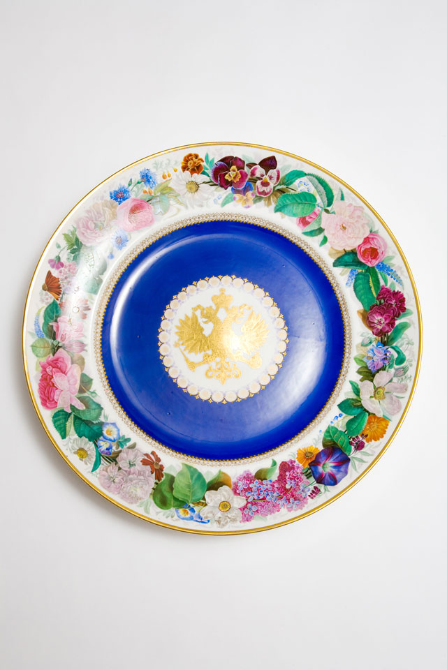 Large, circular Popov porcelain dish with gilt Russian eagle reserved on dark blue ground and rim decorated with brightly painted flowers